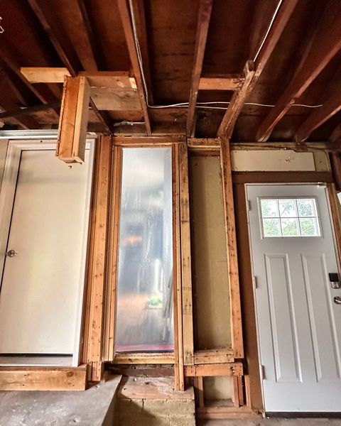 Day 1: interior wall opened to the framing around a window after water got into the walls, Overland Park, KS